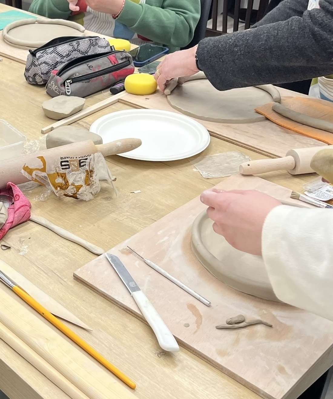 Hands shaping clay during a ceramic sculpture workshop at Arte Fino in Nicosia